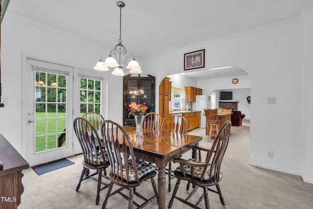 9633 Grassy Creek Rd, Bullock, NC 27507 - dining area featuring arched walkways, healthy amount of natural light, ornamental molding, and light carpet