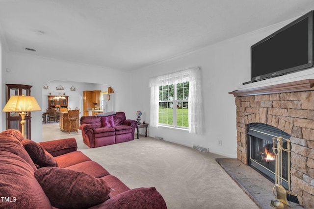 9633 Grassy Creek Rd, Bullock, NC 27507 - living area with carpet flooring, a stone fireplace, and arched walkways