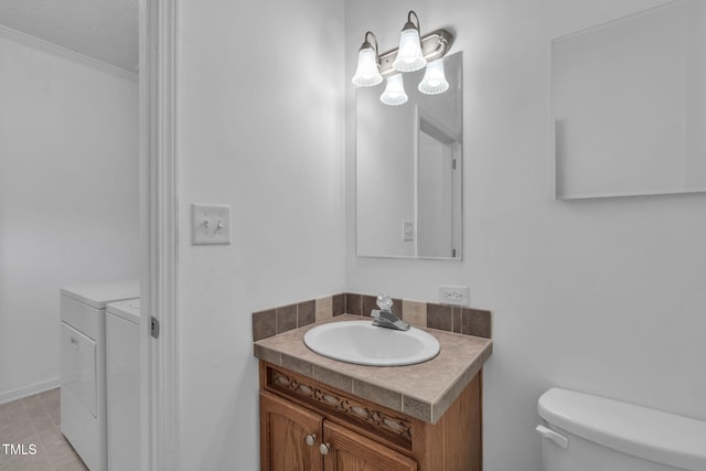 9633 Grassy Creek Rd, Bullock, NC 27507 - half bath with washing machine and clothes dryer, vanity, and ornamental molding