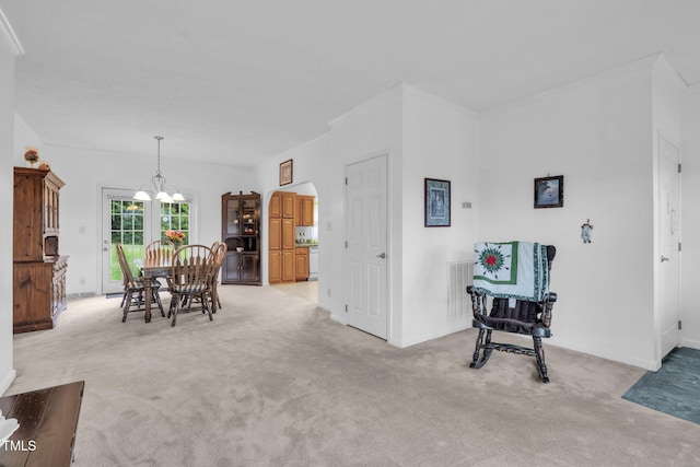 9633 Grassy Creek Rd, Bullock, NC 27507 - dining room with light colored carpet, a chandelier, and arched walkways