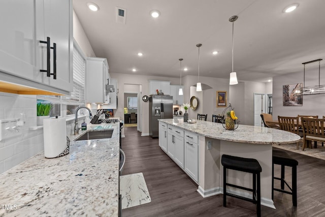 2370 Friars Head Ct, Fuquay Varina, NC 27526 - kitchen with stainless steel fridge, a spacious island, decorative backsplash, white cabinets, and recessed lighting