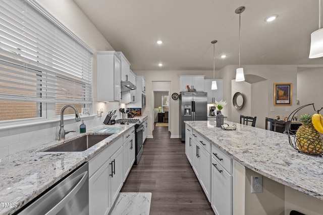 2370 Friars Head Ct, Fuquay Varina, NC 27526 - kitchen with appliances with stainless steel finishes, white cabinets, dark wood-type flooring, light stone counters, and decorative light fixtures