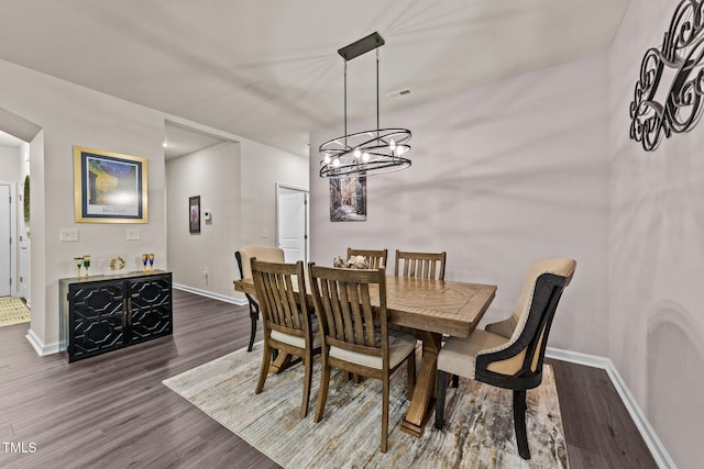 2370 Friars Head Ct, Fuquay Varina, NC 27526 - dining room with dark wood-style floors and a chandelier