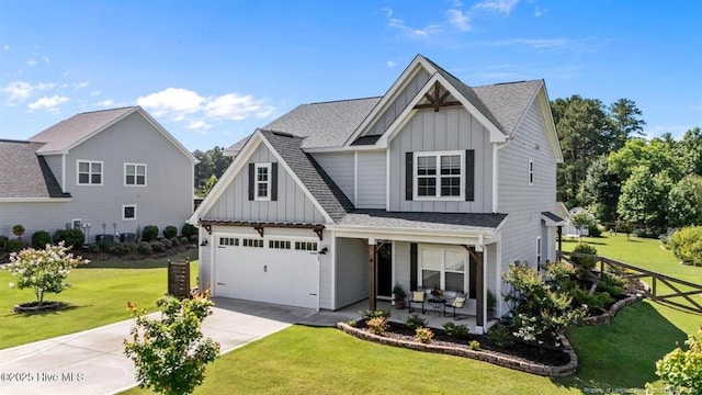 829 Warwick Ln, Carthage, NC 28327 - view of front of property with board and batten siding, driveway, an attached garage, and a front lawn
