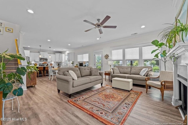 829 Warwick Ln, Carthage, NC 28327 - living area with a ceiling fan, light wood-style floors, a fireplace, recessed lighting, and crown molding
