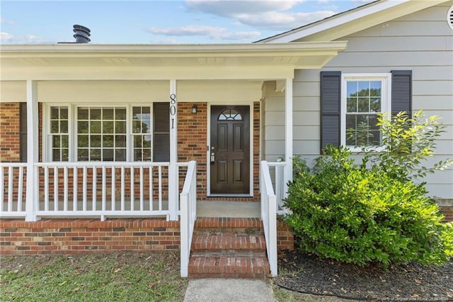 801 Algood Ave, Hope Mills, NC 28348 - doorway to property featuring a porch and brick siding