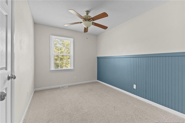 801 Algood Ave, Hope Mills, NC 28348 - spare room featuring a ceiling fan, carpet, and a textured ceiling