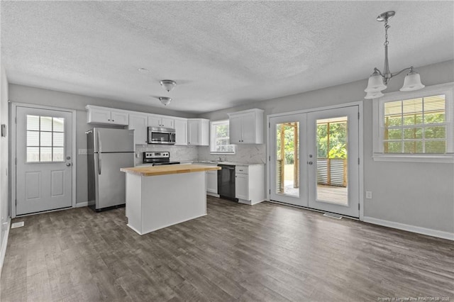 801 Algood Ave, Hope Mills, NC 28348 - kitchen with stainless steel appliances, wood counters, dark wood-style flooring, a textured ceiling, and white cabinetry