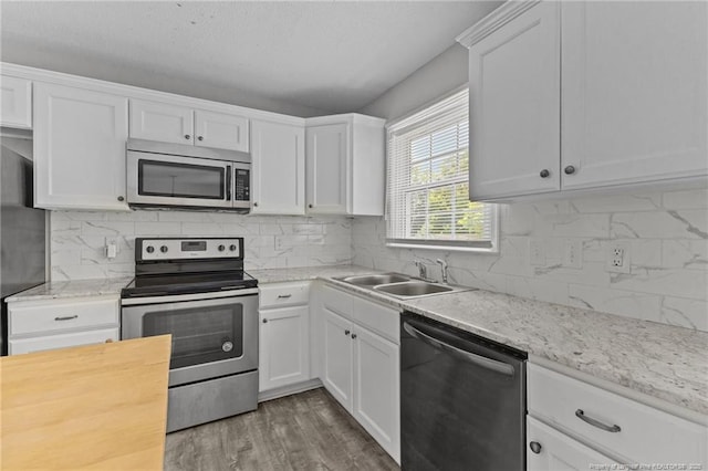 801 Algood Ave, Hope Mills, NC 28348 - kitchen with appliances with stainless steel finishes, white cabinets, decorative backsplash, wood finished floors, and wooden counters