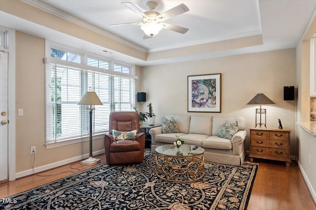 4742 Ludwell Branch Ct, Raleigh, NC 27612 - living room featuring a ceiling fan, ornamental molding, healthy amount of natural light, wood finished floors, and a tray ceiling