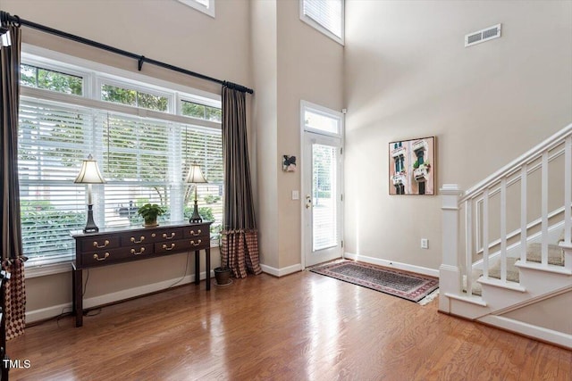 4742 Ludwell Branch Ct, Raleigh, NC 27612 - foyer entrance with wood finished floors, stairs, and a towering ceiling