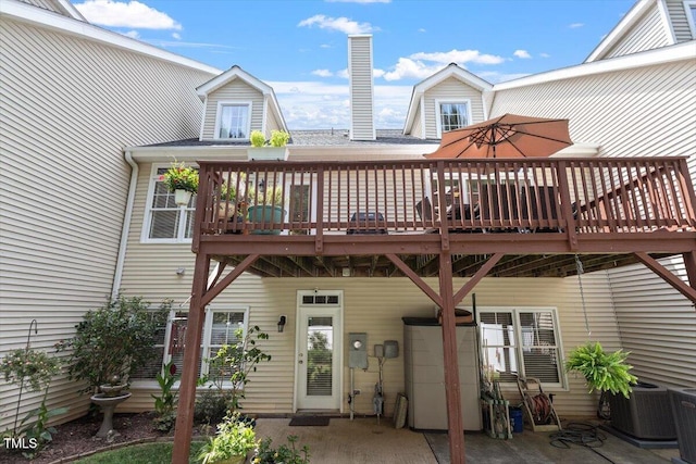 4742 Ludwell Branch Ct, Raleigh, NC 27612 - rear view of house with a wooden deck, a chimney, and a patio area