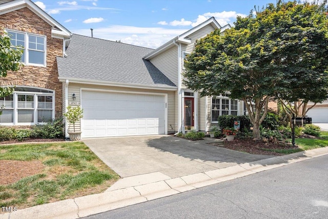 4742 Ludwell Branch Ct, Raleigh, NC 27612 - view of front of home featuring an attached garage, stone siding, concrete driveway, and roof with shingles