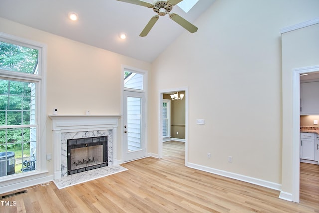 119 Heatherwood Dr, Apex, NC 27502 - unfurnished living room featuring high vaulted ceiling, a premium fireplace, a ceiling fan, healthy amount of natural light, and light wood finished floors