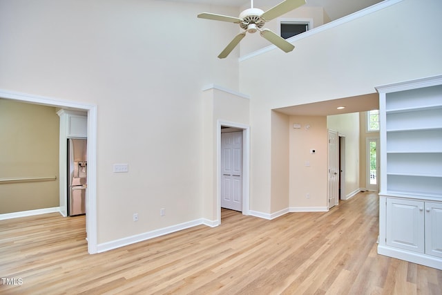 119 Heatherwood Dr, Apex, NC 27502 - unfurnished living room with a high ceiling, a ceiling fan, and light wood-style floors