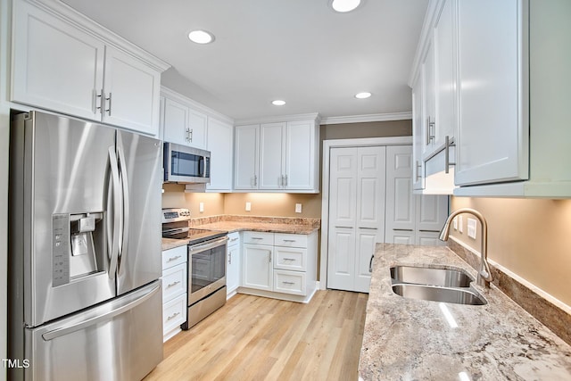 119 Heatherwood Dr, Apex, NC 27502 - kitchen featuring appliances with stainless steel finishes, white cabinetry, light stone counters, recessed lighting, and crown molding