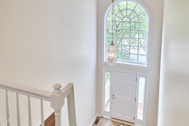 119 Heatherwood Dr, Apex, NC 27502 - foyer entrance with plenty of natural light, light wood-style floors, a chandelier, and a towering ceiling