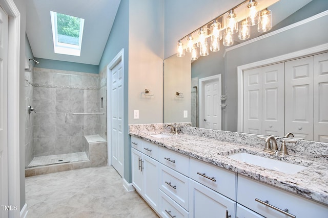 119 Heatherwood Dr, Apex, NC 27502 - bathroom featuring a skylight, double vanity, a tile shower, a closet, and vaulted ceiling