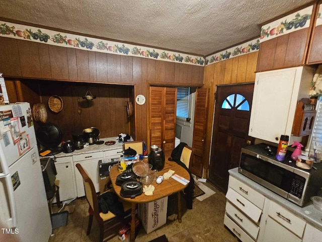 2928 N Patterson Ave, Winston-Salem, NC 27105 - dining space with a textured ceiling and wooden walls