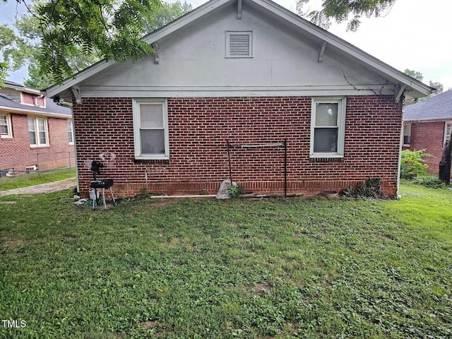 2928 N Patterson Ave, Winston-Salem, NC 27105 - view of side of home featuring brick siding and a lawn