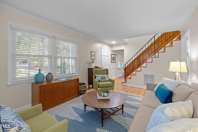 101 Hunter Pl, Carrboro, NC 27510 - living room with stairway, ornamental molding, healthy amount of natural light, and wood finished floors