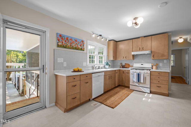 101 Hunter Pl, Carrboro, NC 27510 - kitchen with white appliances, under cabinet range hood, light countertops, and decorative backsplash