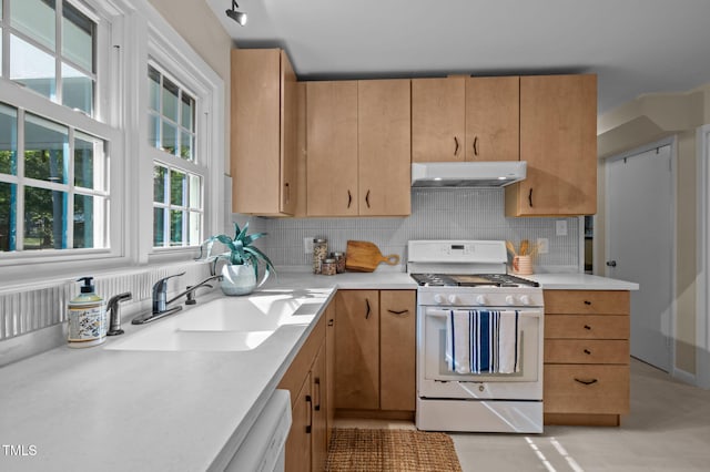 101 Hunter Pl, Carrboro, NC 27510 - kitchen with white appliances, under cabinet range hood, backsplash, and light countertops