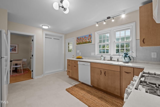 101 Hunter Pl, Carrboro, NC 27510 - kitchen with white appliances, light countertops, tasteful backsplash, and light flooring