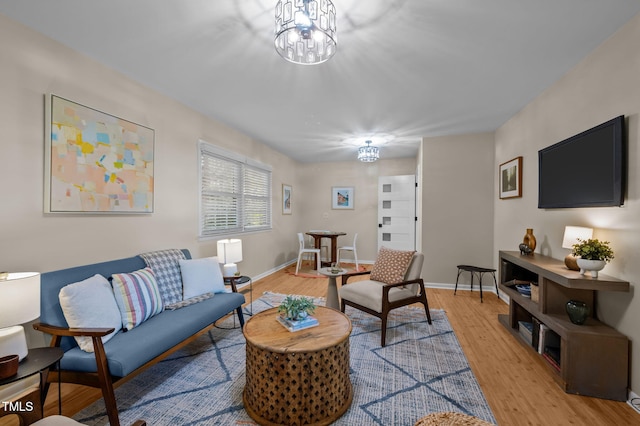 101 Hunter Pl, Carrboro, NC 27510 - living room featuring light wood-type flooring and a chandelier