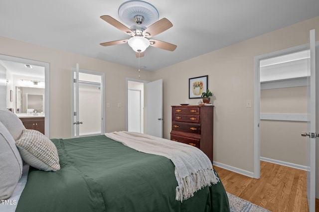 101 Hunter Pl, Carrboro, NC 27510 - bedroom with a walk in closet, light wood-type flooring, ceiling fan, and connected bathroom