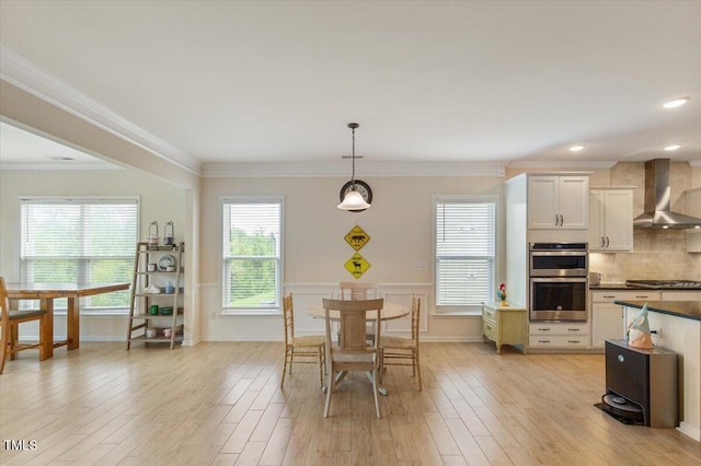 470 Duggins Pt, Apex, NC 27523 - dining room with light wood-style flooring, ornamental molding, a wainscoted wall, and recessed lighting