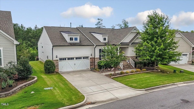 470 Duggins Pt, Apex, NC 27523 - view of front of home featuring concrete driveway, a front lawn, a shingled roof, a garage, and stone siding