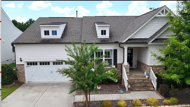 470 Duggins Pt, Apex, NC 27523 - view of front of house featuring a shingled roof, stone siding, concrete driveway, and a garage