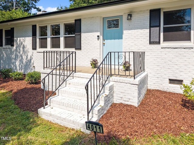 4011 Garrett Rd, Durham, NC 27707 - view of exterior entry featuring brick siding and crawl space