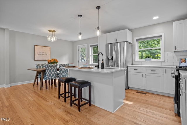 4011 Garrett Rd, Durham, NC 27707 - kitchen with stainless steel appliances, light wood finished floors, healthy amount of natural light, light countertops, and recessed lighting