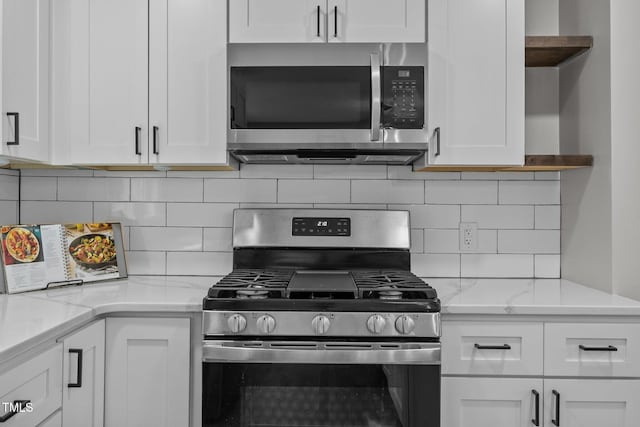 4011 Garrett Rd, Durham, NC 27707 - kitchen with stainless steel appliances, white cabinets, open shelves, and tasteful backsplash