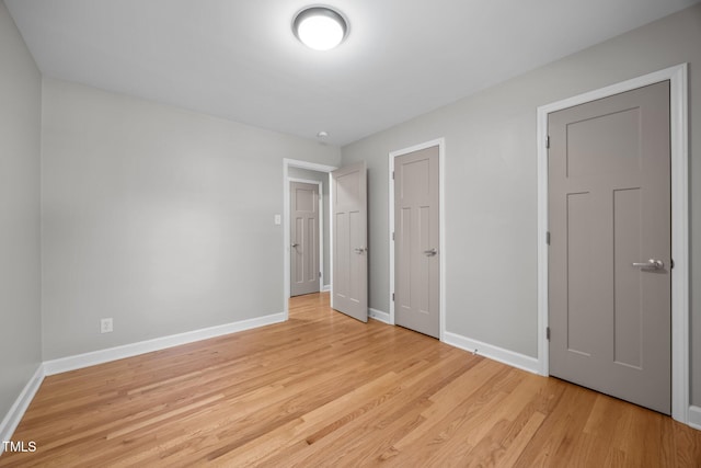 4011 Garrett Rd, Durham, NC 27707 - unfurnished bedroom with baseboards and light wood finished floors