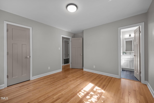 4011 Garrett Rd, Durham, NC 27707 - unfurnished bedroom with light wood finished floors and connected bathroom
