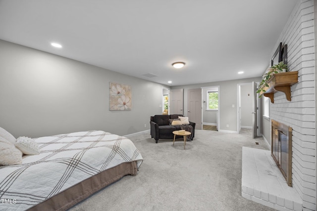 4011 Garrett Rd, Durham, NC 27707 - bedroom featuring a brick fireplace, light colored carpet, and recessed lighting