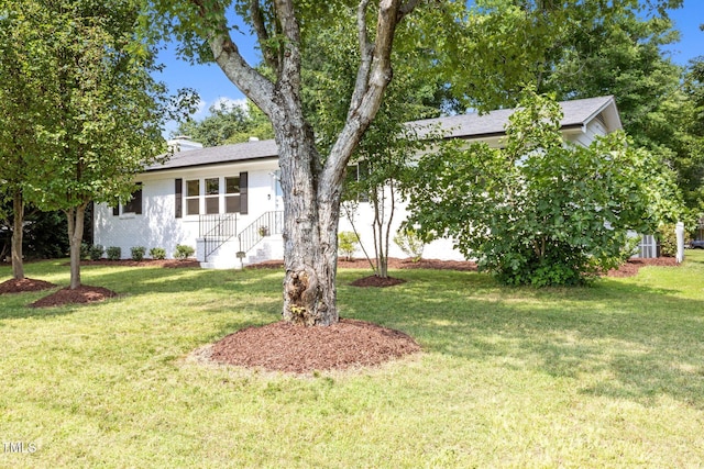 4011 Garrett Rd, Durham, NC 27707 - view of front of house featuring a front yard, brick siding, and roof with shingles