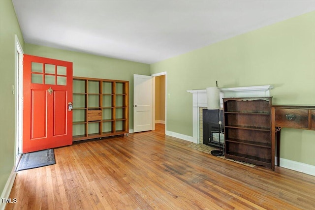 1300 Ruffin St, Durham, NC 27701 - unfurnished living room featuring wood finished floors and a fireplace with flush hearth