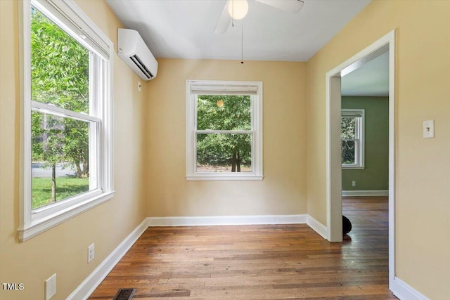 1300 Ruffin St, Durham, NC 27701 - unfurnished room with a wall mounted AC, wood finished floors, and ceiling fan