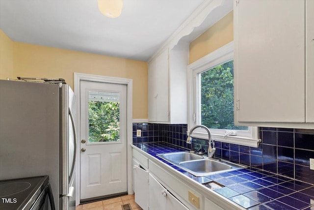 1300 Ruffin St, Durham, NC 27701 - kitchen featuring tile countertops, white cabinetry, and healthy amount of natural light