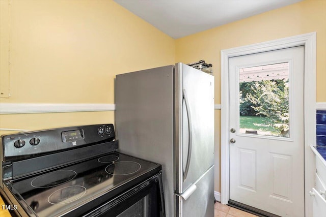 1300 Ruffin St, Durham, NC 27701 - kitchen with electric range, freestanding refrigerator, and light tile patterned floors