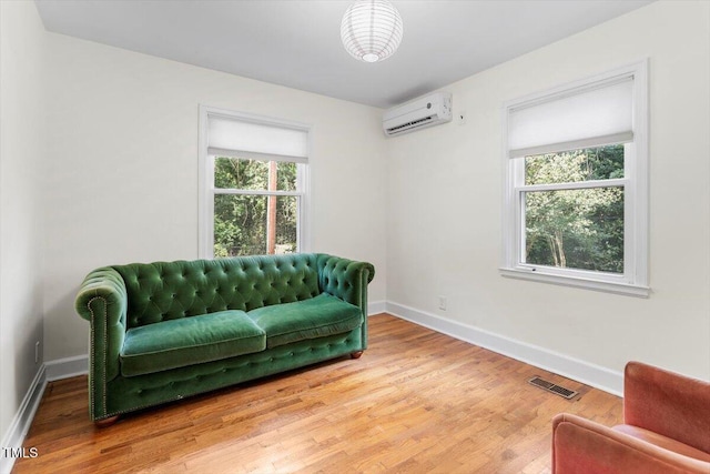 1300 Ruffin St, Durham, NC 27701 - sitting room with a wall unit AC and wood finished floors