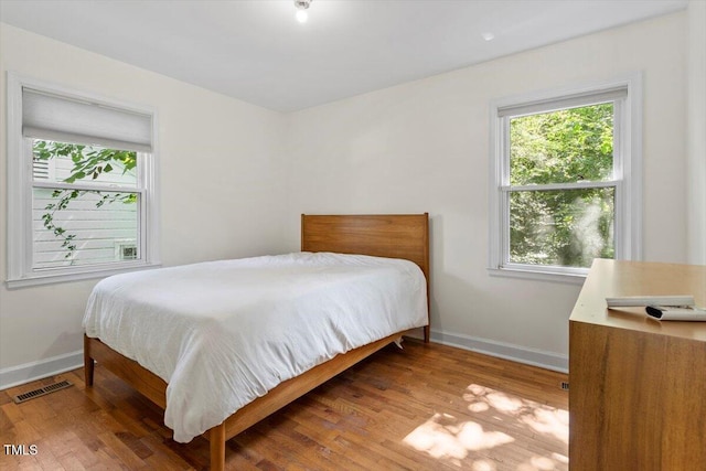 1300 Ruffin St, Durham, NC 27701 - bedroom with multiple windows and wood finished floors