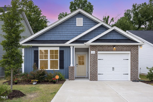 331 Sturgeon St, Smithfield, NC 27577 - view of front of property with concrete driveway, a garage, brick siding, and board and batten siding