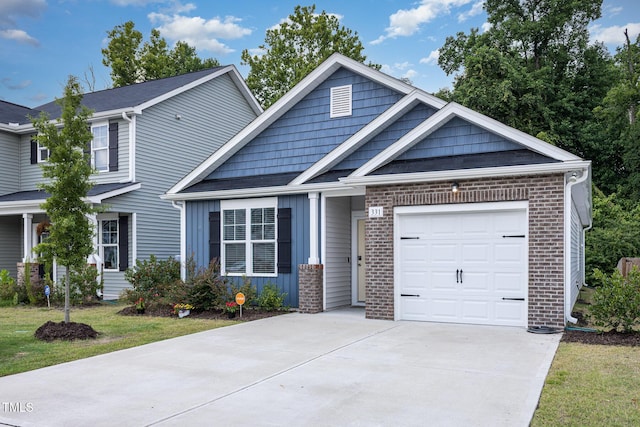 331 Sturgeon St, Smithfield, NC 27577 - craftsman-style house featuring a garage, driveway, board and batten siding, and brick siding