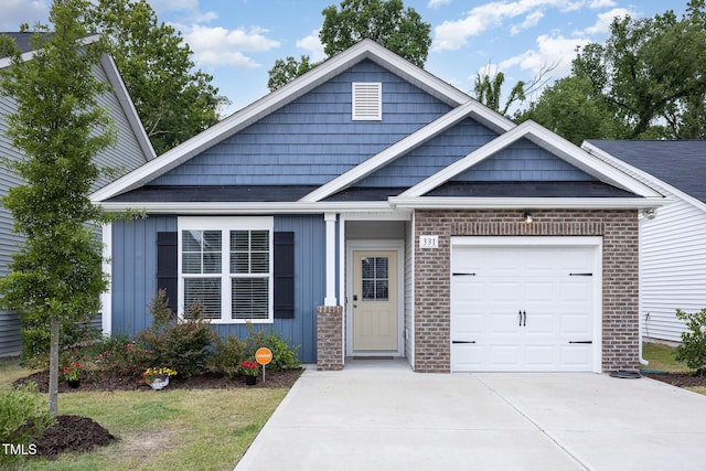331 Sturgeon St, Smithfield, NC 27577 - view of front of property featuring driveway, an attached garage, brick siding, and board and batten siding