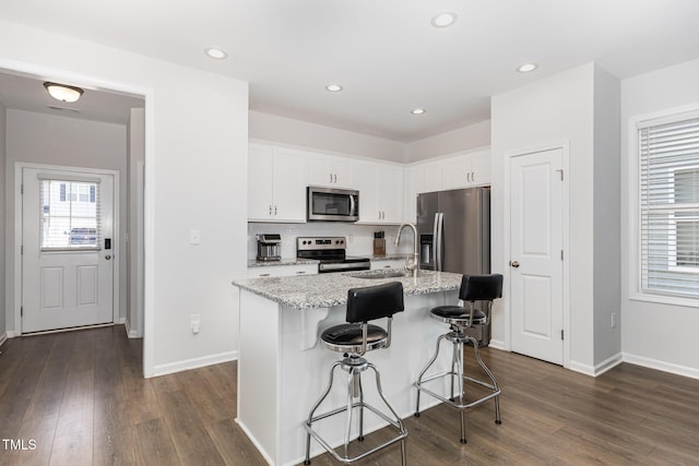 331 Sturgeon St, Smithfield, NC 27577 - kitchen featuring appliances with stainless steel finishes, white cabinets, dark wood-style flooring, and recessed lighting